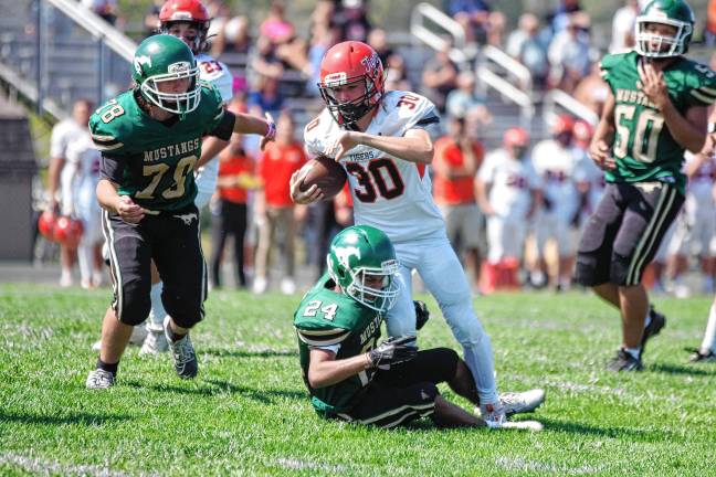 <b>ST1 Hackettstown ball carrier Carter Grant is tackled by Sussex Tech defender Anthony Caroleo in their game Saturday, Sept. 13. The Mustangs lost, 51-0, at home.</b>