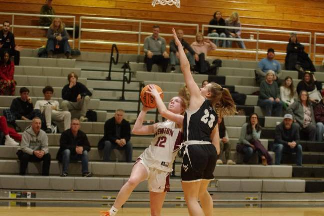 Newton's Avery Eigner (12) prepares to shoot while covered by Wallkill Valley's Jackie Schels. Eigner scored four points in the game.