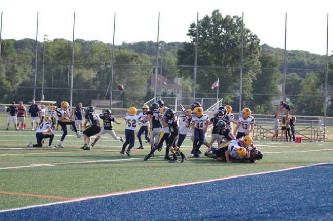 Wallkill Valley Ranger Cole Weekley (27) blocks an extra point kick attempt by the Jefferson Township Falcons in the seventh-grade scrimmage.