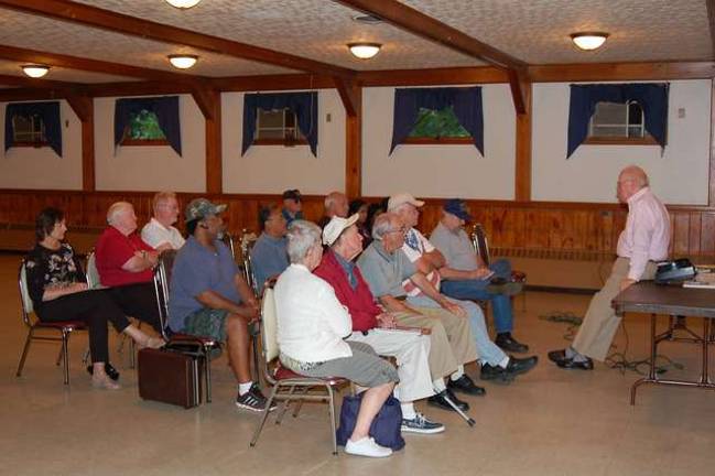 James Kane addresses the audience in the meeting room of the American Legion Post 423. Using various slides and audio tapes, he described how the conditions were when the United States and members of the United Nations fought the North Koreans to preserve the government of South Korea and to prevent the spread of communism. He spoke of a number of battles, including the battle of the Chosin Reservoir where Marine and Army troops fought their way to the coastal city of Hungnam where they were evacuated.