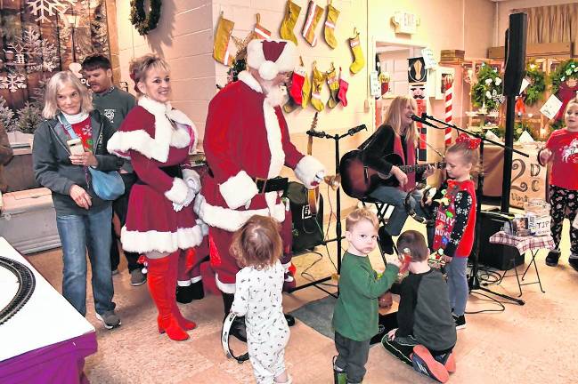 Santa and Mrs. Claus greet the children.