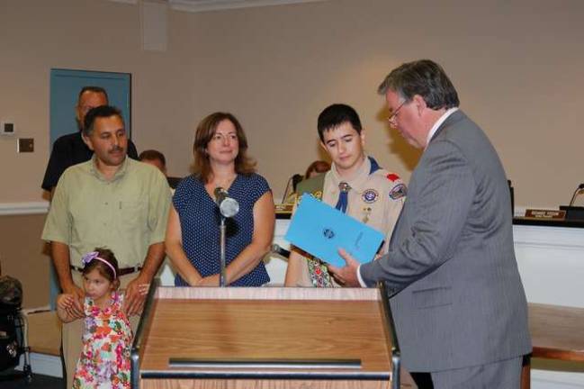 Jefferson Township Mayor Russell Felter reads a Proclamation from the township to Nolan Doyle congratulating him on achieving the rank of Eagle Scout in Boy Scout Troop 49. His father, mother and sister look on. He was also congratulated by the members of the Council.