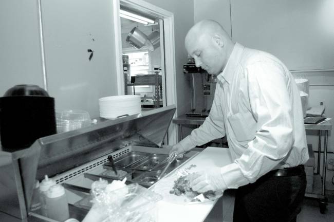 Photo by Chris Wyman Bo Kennedy assembles a dish for a customer.