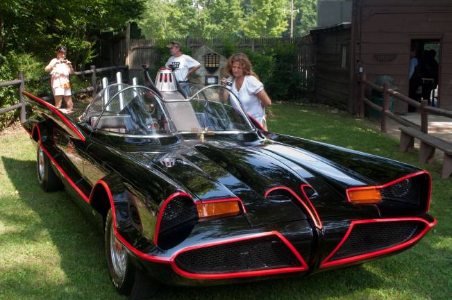 Visitors admire and photographing the reproduction of the 1960's Batmobile.
