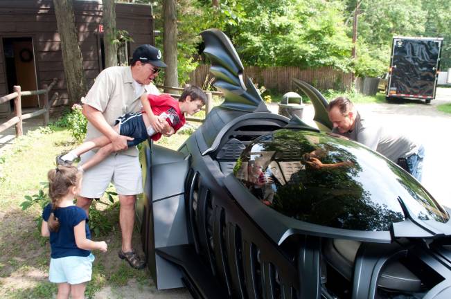 Gary Butchelder from the Poconos helping his kids take a closer look at the Batmobile.