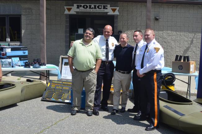 From left, Franklin Mayor Nick Giordano, Detective-Lieutenant Nevin Mattessich, U.S. Rep. Josh Gottheimer, Police Chief Gregory Cugliari, and Captain Seamus Geddis pose in front of the equipment obtained through a Military Surplus program.