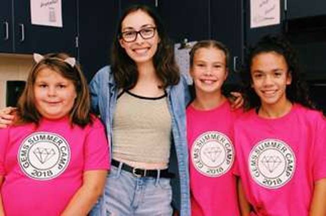 Larissa Collins, Sussex County Technical School senior and GEMS host, with campers.