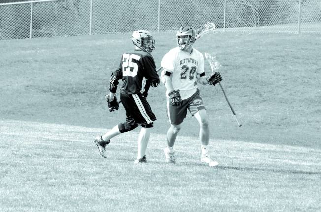 Wallkill's Jerry Struble shadows Kittatinny's Garrett Armstrong. Kittatinny Regional High School defeated Wallkill Valley Regional High School in boys varsity lacrosse on Monday, April 28, 2014. The final score was 20-5. Kittatinny clinched the NJAC Independence Division for its first championship in program history. The game took place at Kittatinny Regional High School in Newton, New Jersey.