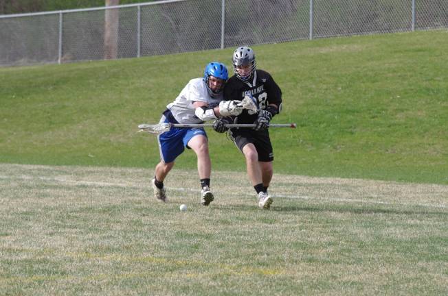 Kittatinny's Dan Laemers challenges Wallkill's Andrew Reed for the ball. Kittatinny Regional High School defeated Wallkill Valley Regional High School in boys varsity lacrosse on Monday, April 28, 2014. The final score was 20-5. Kittatinny clinched the NJAC Independence Division for its first championship in program history. The game took place at Kittatinny Regional High School in Newton, New Jersey.