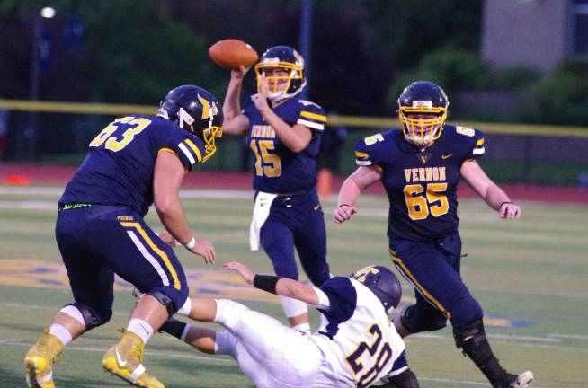 Vernon offensive linemen Walt Lecaros (63) and Sean Gleason (65) protect their quarterback Daniel Fedorko (15) from Jefferson linebacker Michael Fleming. Jefferson Township High School (Oak Ridge, N.J.) defeated Vernon Township High School in varsity football on Friday, September 15, 2017. The final score was 16-6. Vernon Township High School in Glenwood, N.J.) hosted the game.