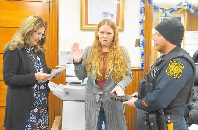 From left, Borough Clerk Robin Hough administers the Oath of Office to Councilwoman Brenda O'Dell, with Patrolman David Cowdrick on right.