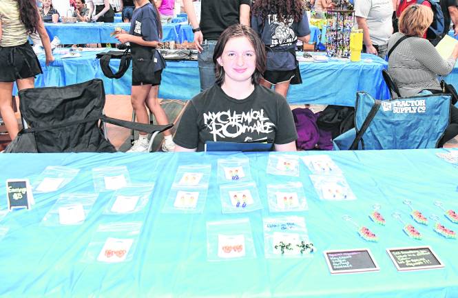 Josephine Herrick is of Kandi Creations sits at her table.
