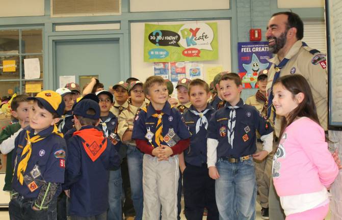 Scouts share one last laugh with Cubmaster Akela Carlos Soares.