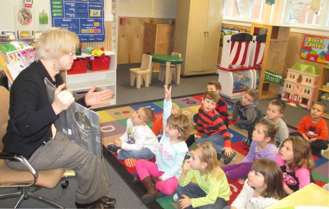 Class 4D listens to Jenise Sileo of the Sussex County Library as she reads story to children.