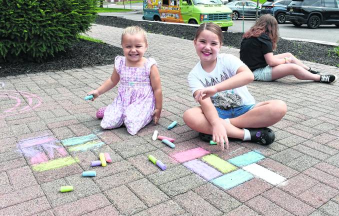 Addison and Isabella Smith of Ogdensburg pose next to their art.
