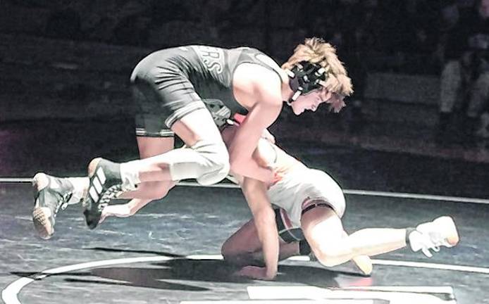 Wallkill Valley's Alekos Reinle goes airborne while wrestling Hackettstown's Adrian Pinto at 138 pounds. Pinto won by major decision (14-3).