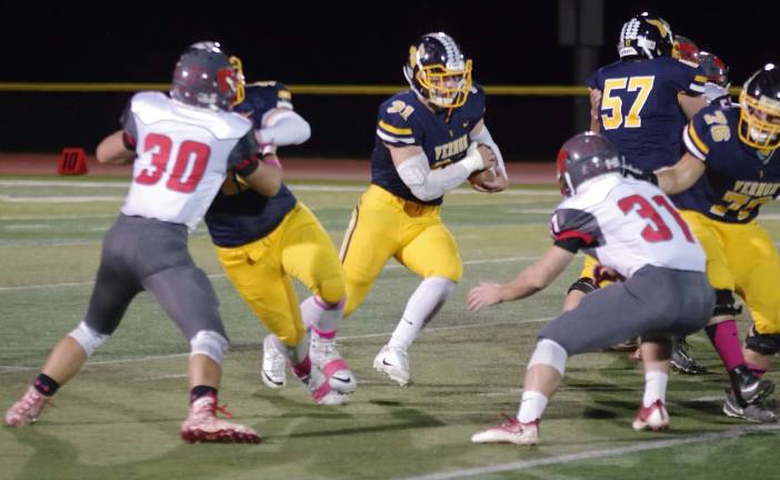 Vernon running back Mike Stefkovich moves forward with the ball in the first quarter.