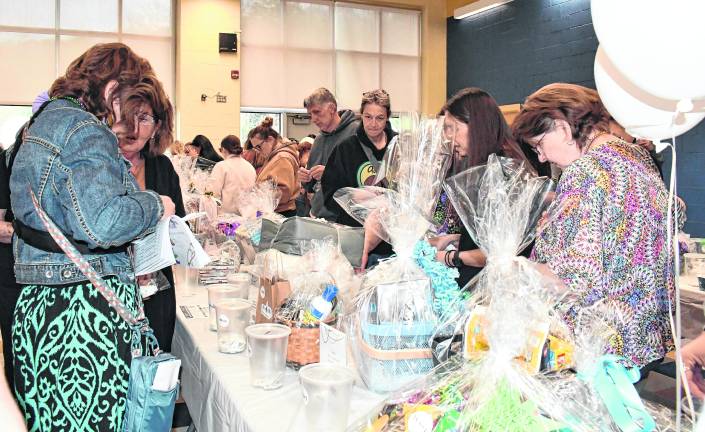 Visitors peruse the baskets to be bid on.