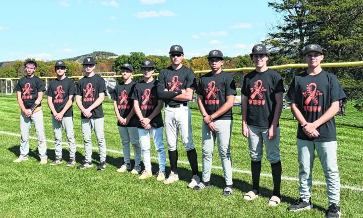 Members of the Wallkill Valley baseball team pose along the foul line.