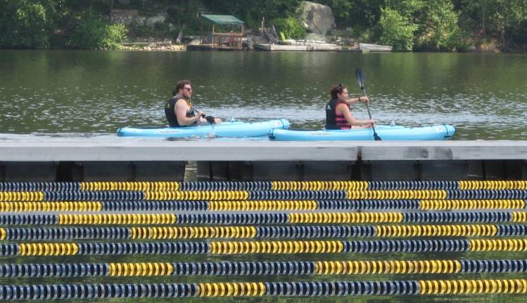 PHOTO BY JANET REDYKEKayaks and their riders stream along the Main Lake of Highland Lakes on a hot, humid Sunday.