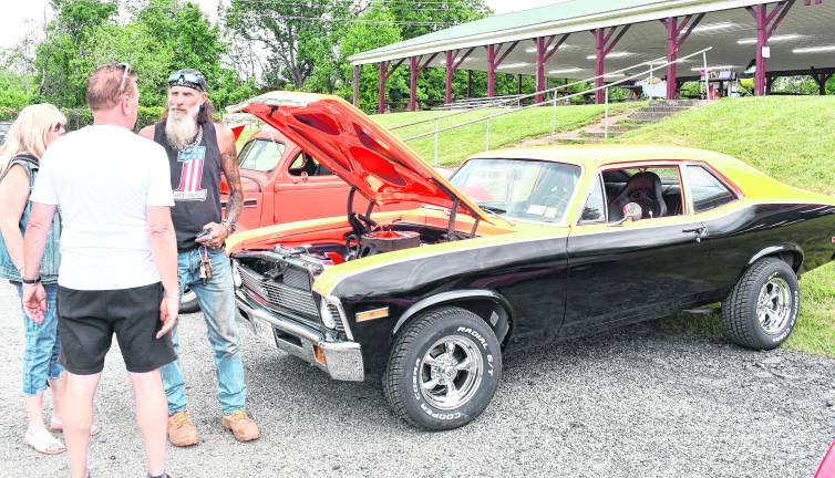 Joseph Dunko of Warwick, N.J., shows his car to two visitors.