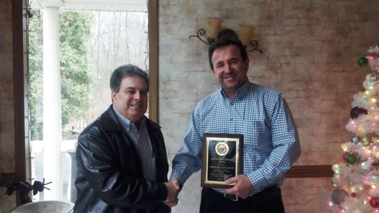 Joe Ozoniak, left, of the Knights of Columbus presents a plaque to Mindy Asani of Portofino's Restaurant in Oak Ridge.