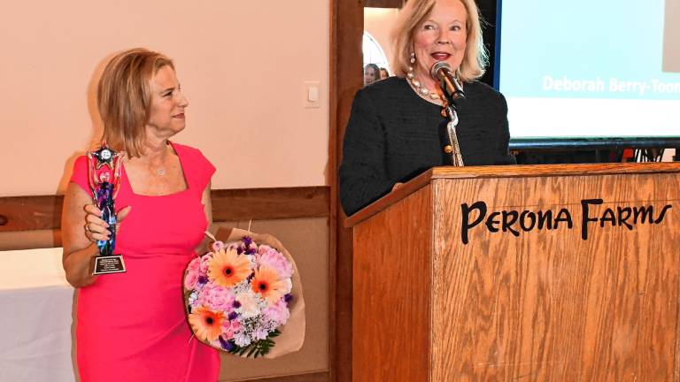 Tammie Horsfield, left, president of the Sussex County Chamber of Commerce, holds the Woman of the Year award for Deborah Berry-Toon, executive director of Project Self-Sufficiency. (Photos by Maria Kovic)