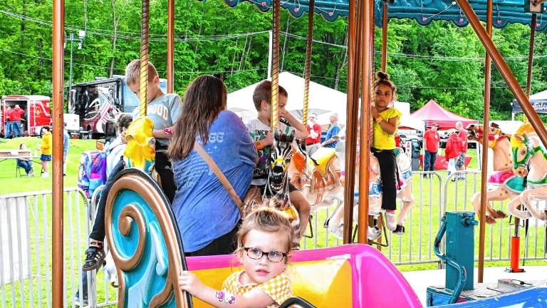Penelope Ruvo rides the merry-go-round Friday, May 30 at the Firemen’s Carnival in Oak Ridge. (Photos by Maria Kovic)