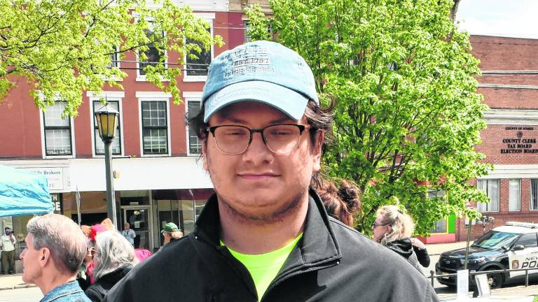 Eric Cortes holds a sign supporting the ACLU.