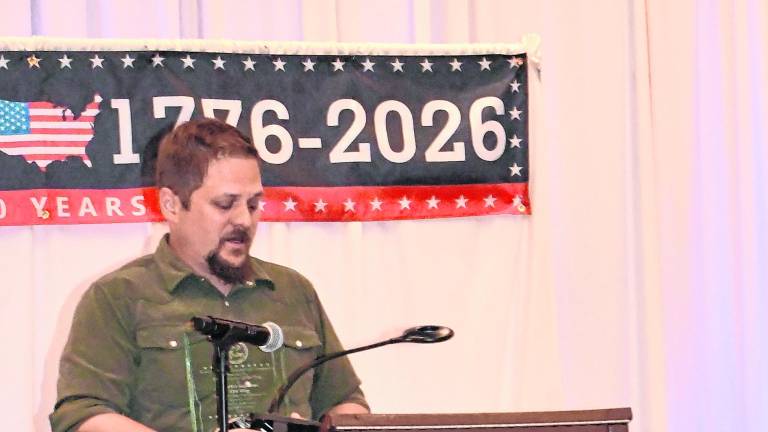 Enterpreneur of the Year Award went to Charles Kuperus, Tire King. Pictured is his son, John Kuperus, who accepted the award on his father's behalf.