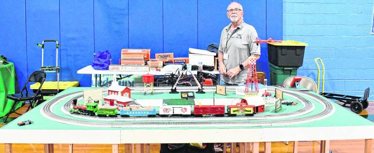 Rich Schubert of Byram poses behind a train setup.