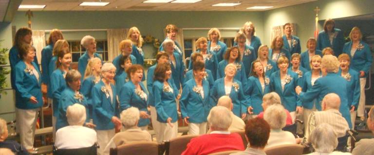 Harmony in Motion's chorus sharing harmony with the residents of Bristol Glen in Newton at a recent holiday performance.