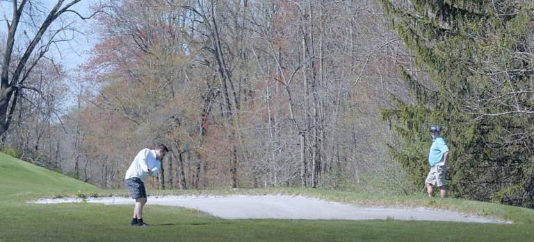 Golfers come out swinging amid the budding trees at Great Gorge Golf Course.