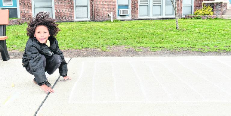 Lucas Nelsen shows off chalk art.