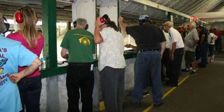 One-on-one coaching is a hallmark of the four-hour class. The shooter's gun is clcosely watched to make sure it is always pointed in a safe direction.