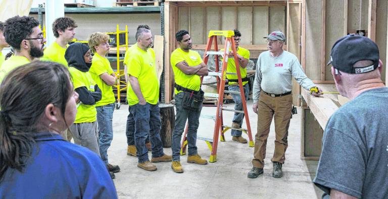 Stan Hankison instructs a plumbing class.