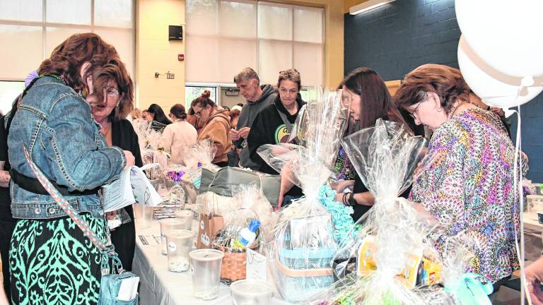 Visitors peruse the baskets to be bid on.