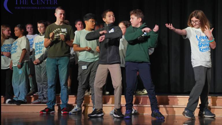 <b>Students perform on stage.</b>