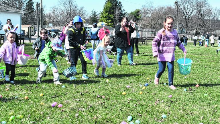 Ogdensburg children run out to hunt Easter eggs.