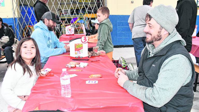 Anna Vinales and her father, Don, play cards.