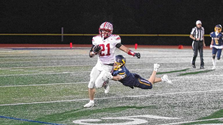 High Point ball carrier Brendon Lehman is caught from behind by Vernon defender Gavin Bruno in the second quarter. The Vikings won, 35-28, at home Friday, Oct. 3. (Photos by George Leroy Hunter)