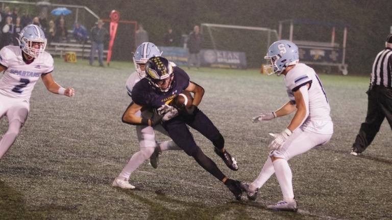 After catching the ball, Jefferson wide receiver Jeffrey Evans tries to break away from a Sparta defender. Evans caught a touchdown pass in the fourth quarter. (Photos by George Leroy Hunter)