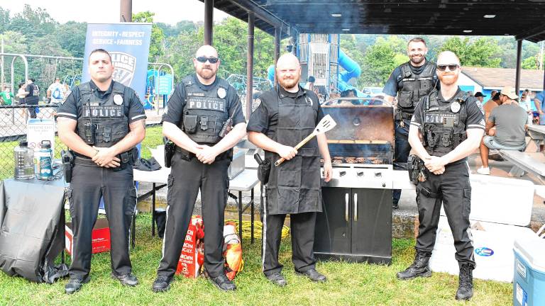 Police officers man the grill during the National Night Out event Tuesday, Aug. 5 in Franklin. (Photos by Maria Kovic)