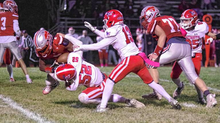 <b>High Point ball carrier A.J. Sampson is tackled by Lenape Valley defender Chase Grant (52) in the first half of their game Friday, Oct. 10 in Sussex. The Wildcats won, 35-6. (Photos by George Leroy Hunter)</b>