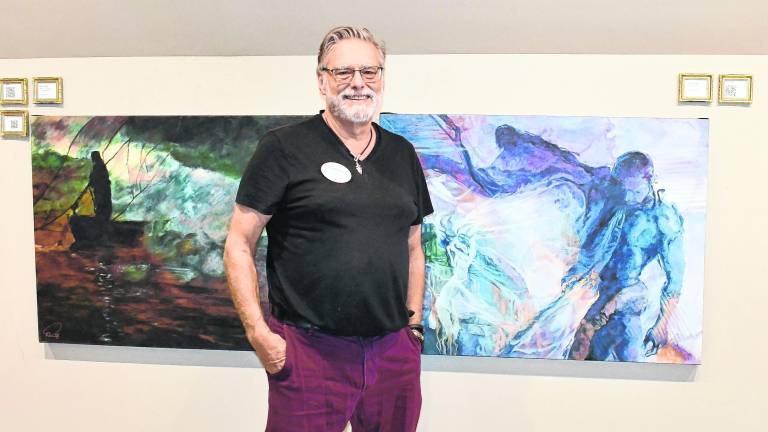 David Derr stands next to his favorite painting Realising the Fury.