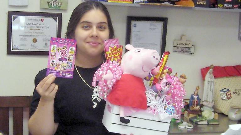 Sweet Twins Candy and Varieties owner Melissa Fernandez with the gift set raffle prize (Photo by Janet Redyke)