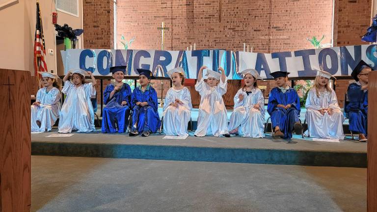 The preschool graduates sit on the altar of the Lutheran Church of Our Savior in Stanhope. (Photos by Theresa Esposito)