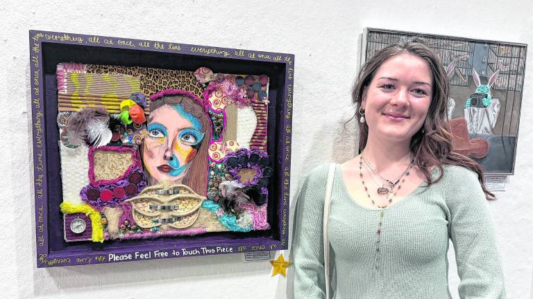 Ashley Caraccio is shown with her scholarship-winning piece.