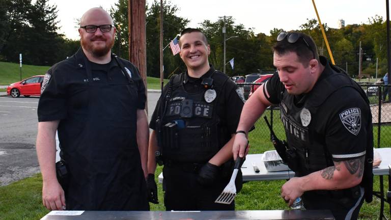 Officer Brendan Prol,Sgt. Robert Vander and Officer Nick Della Fera work the grill.