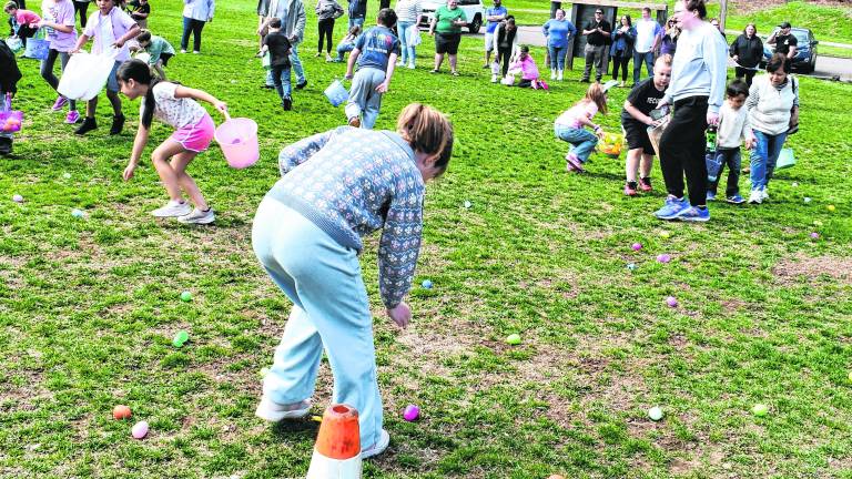 Children pick up Easter eggs.